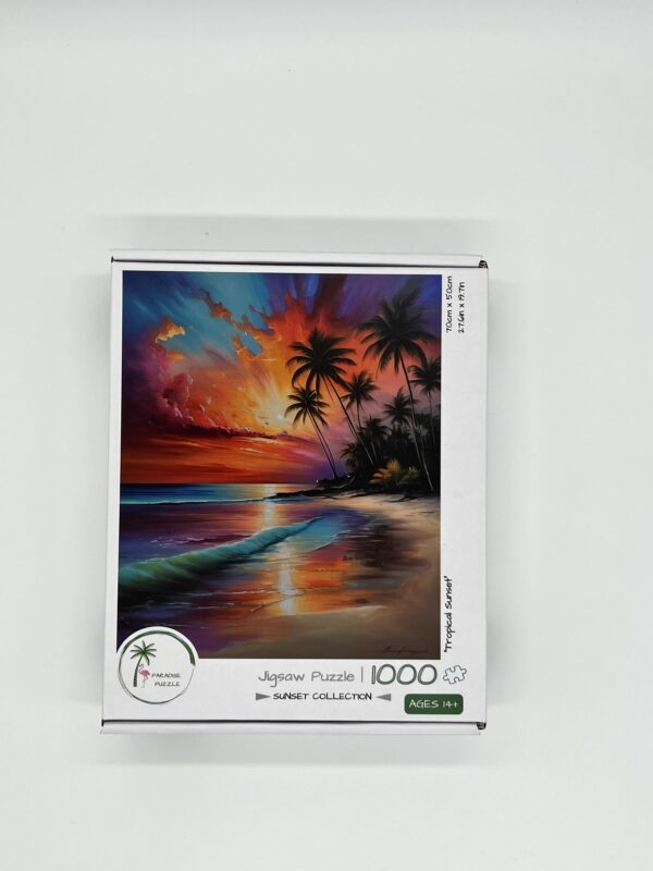 A 1000-piece jigsaw puzzle box displaying a vibrant sunset over an ocean with waves and palm trees. The puzzle is part of the "Sunset Collection" and is suitable for ages 14 and up.